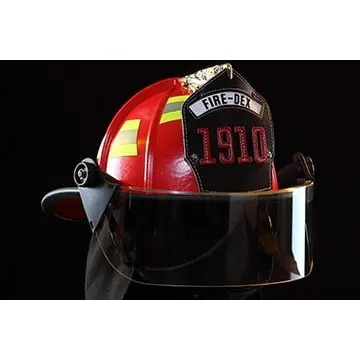 Close-up front right side view of a Fire-Dex® Traditional Helmet in red, emphasizing shell texture, visor area, and reflective details.