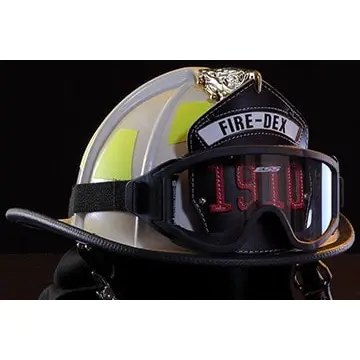 Close-up front right side view of a Fire-Dex® Traditional Helmet in gray, showing detailed shell contours, visor area, and protective trim.