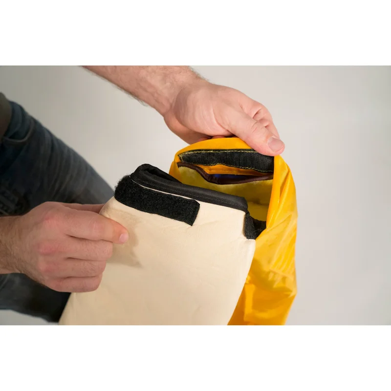 Alternate close-up view of the foam inner buoyancy liner held by the sleeve next to the suit sleeve of the Mustang Survival® Ice Commander Rescue Suit, showcasing the liner’s flotation material, attachment point, and durable interior design.