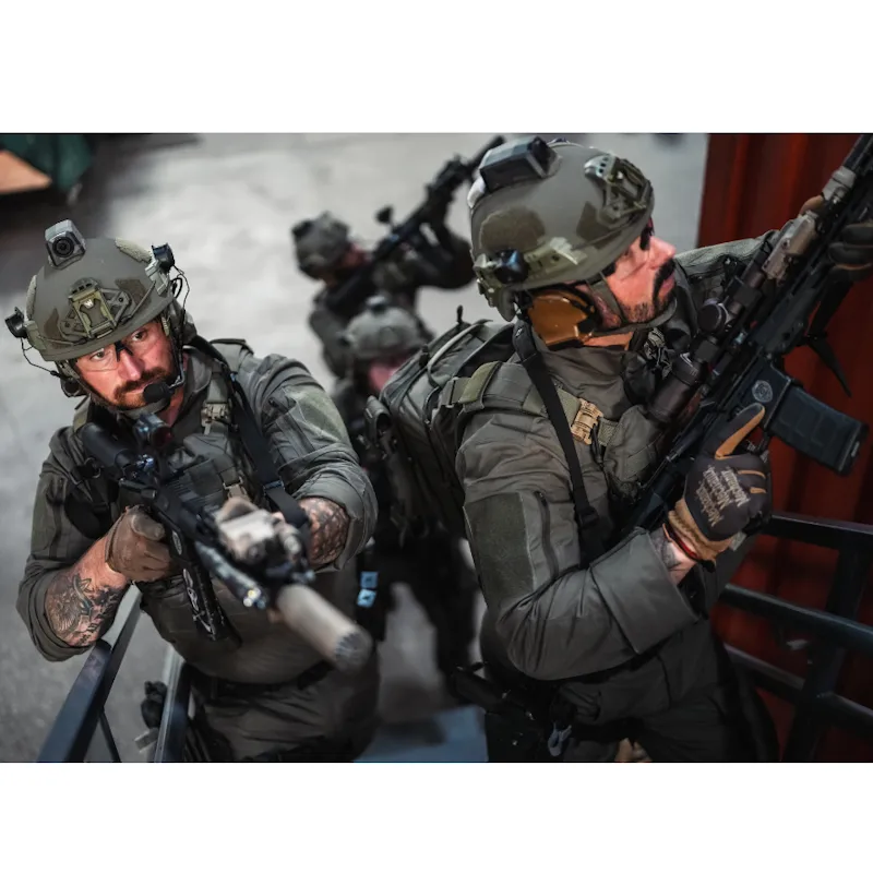 Two soldiers wearing the Team Wendy® EPIC™ Specialist Ballistic Helmet while armed and geared in the field, demonstrating operational readiness and secure, ergonomic fit.