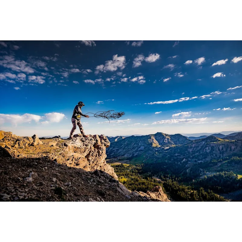 Hiker wearing Team Wendy® SAR™ Backcountry Helmet while trekking outdoors on rugged trails, showcasing lightweight and durable protective gear for outdoor adventures.