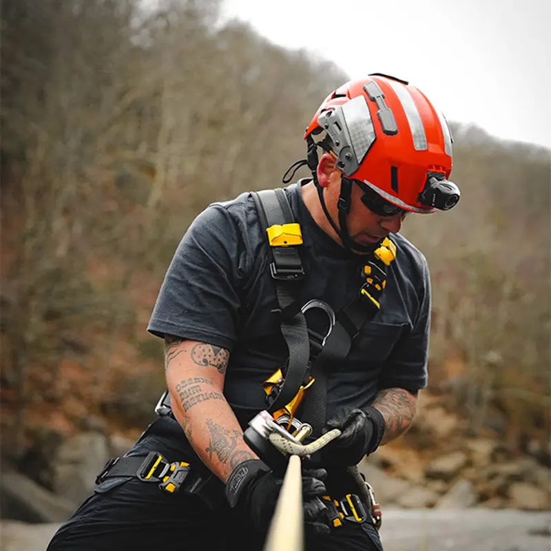 Person wearing the Team Wendy SAR Tactical Helmet with harness outdoors showing safety and secure fit in action.