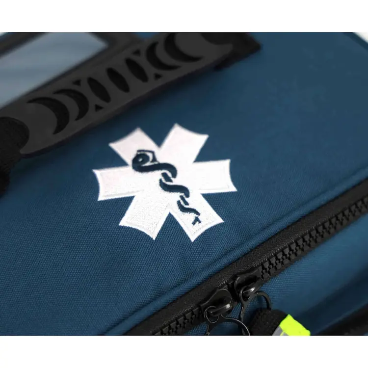 Closeup of Lightning X LXMB25 navy blue variant showing front top section with prominent medical emblem for quick identification in emergencies.