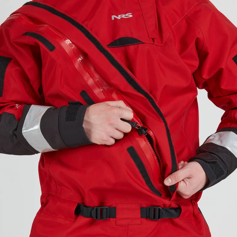 Closeup of a man wearing the NRS Extreme SAR GTX Dry Suit in red, adjusting the heavy-duty front zipper on the chest area.