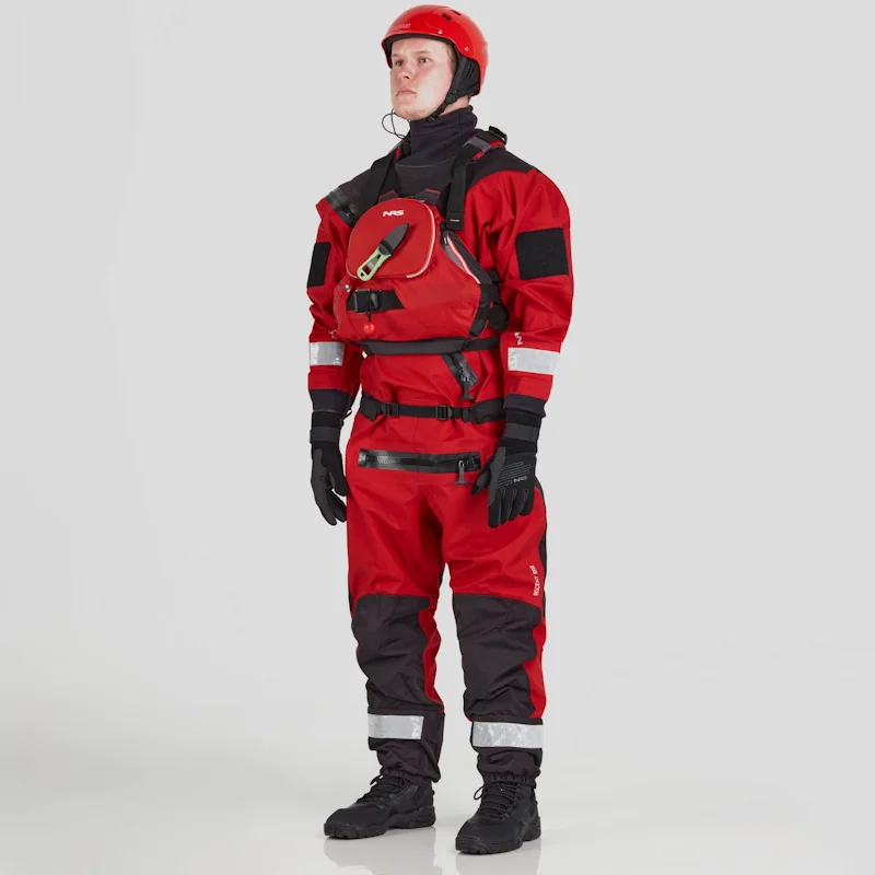 Front side view of a man wearing the NRS Ascent SAR Dry Suit in red with a red equipment bag on the chest, showcasing the waterproof material and rescue gear readiness.
