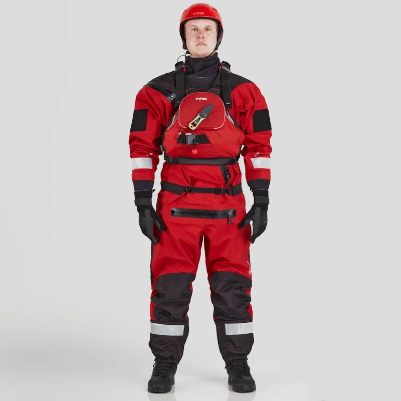 Front view of a man wearing the NRS Ascent SAR Dry Suit in red with a red equipment bag secured on the chest, highlighting the suit’s waterproof fabric and rescue gear setup.