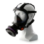 Sundström® SR 200 full face mask in black with a wide clear polycarbonate lens and inner nose cup, shown on a mannequin head with adjustable head straps, a purple-banded filter cartridge on the side, and an orange exhalation valve cover.