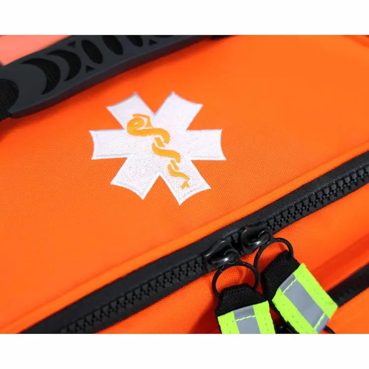 Closeup of Lightning X LXMB25 orange variant showing front top section with prominent medical emblem for quick identification in emergencies.