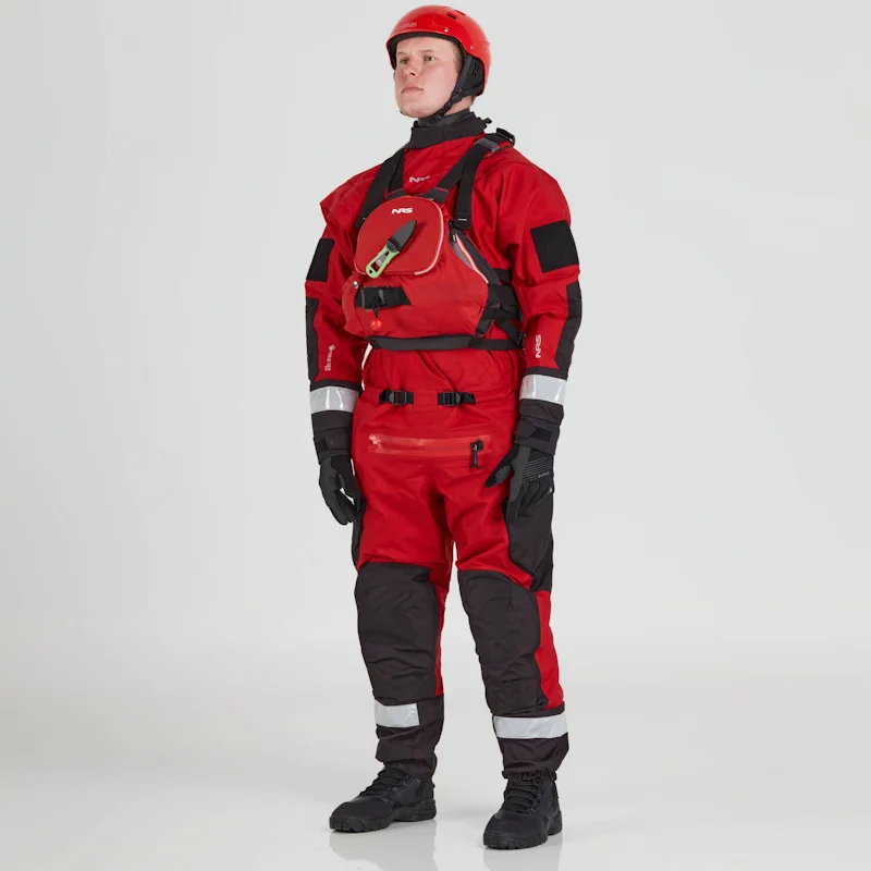 Front side view of a man wearing the NRS Extreme SAR GTX Dry Suit in red with an equipment bag on the chest, showcasing the waterproof material and rescue gear readiness.