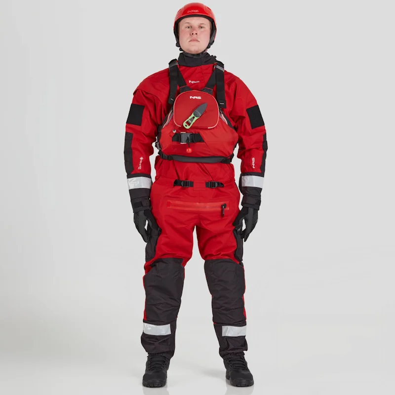 Front view of a man wearing the NRS Extreme SAR GTX Dry Suit in red with an equipment bag secured on the chest, highlighting the suit’s breathable fabric and rescue gear setup.