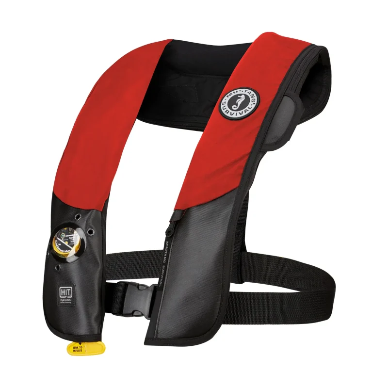 Side front view of Mustang Survival® Hit Hydrostatic Inflatable PFD in red variant highlighting ergonomic fit, inflation cylinder placement, and secure strap system.