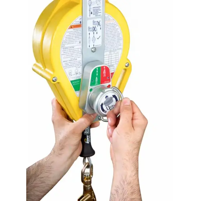 Hands turning the adjustment knob on the 3M™ DBI-SALA® Ultra-Lok™ Self Retracting Lifeline with 50 ft galvanized steel cable, demonstrating equipment setup for fall protection.