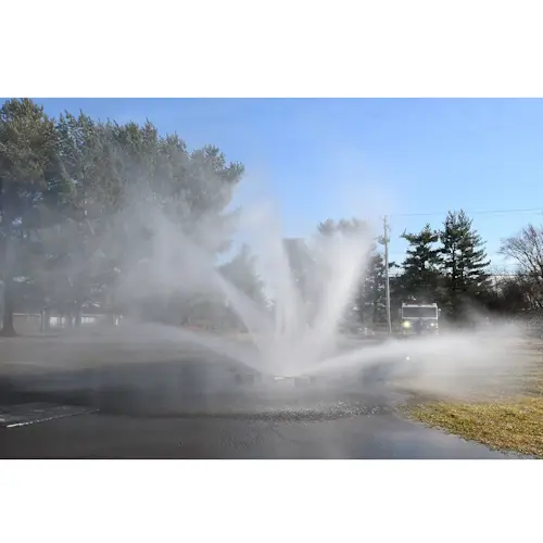 Ziamatic™ Vehicle Cooling Unit in use, spraying a powerful water mist to reduce heat and protect firefighters during emergency operations.