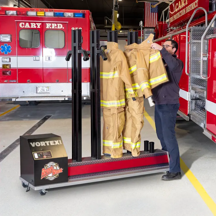 Ready Rack™ Vortex MD5 Mobile Dryer – 5-Position in use, with a firefighter placing gear on the dryer’s racks, showcasing efficient, organized drying of multiple firefighting items.
