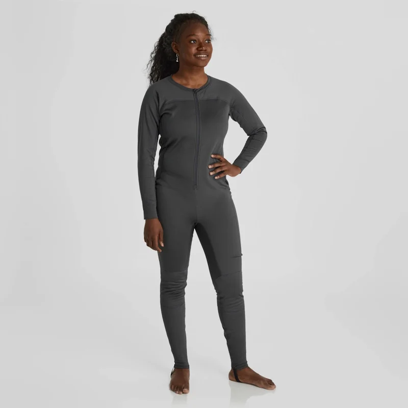 Front side view of a woman wearing the NRS Women’s Expedition Weight Union Suit, highlighting the form-fitting design, full-length zipper, and thermal fleece fabric.