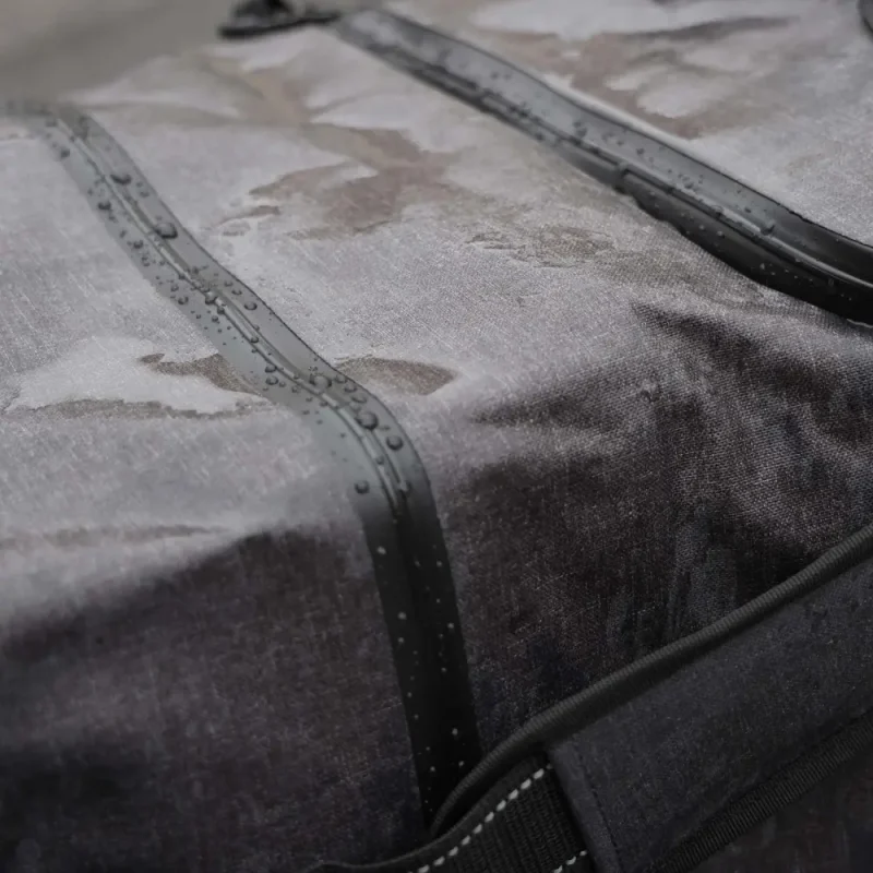 Closeup of top section of Lightning X LXFB99 with rainwater droplets, highlighting waterproof fabric.