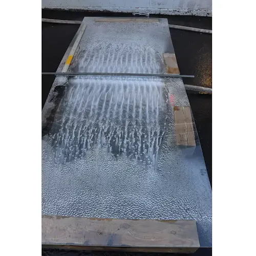 Top view of Ziamatic™ Vehicle Cooling Unit inactive with water running down its exterior, highlighting its durable waterproof design.