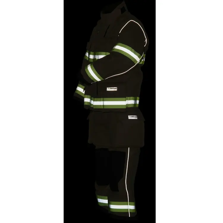Lakeland® Stealth Premium Turnout Coat shown in the dark at night, with reflective striping clearly visible for enhanced firefighter visibility and safety in low-light conditions.