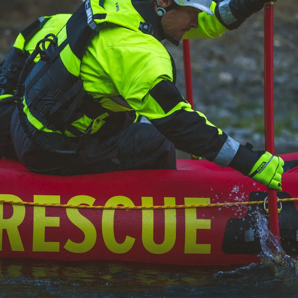 Side view of a rescue worker in active duty wearing NRS Reactor Rescue Gloves for protection and secure grip during operations.