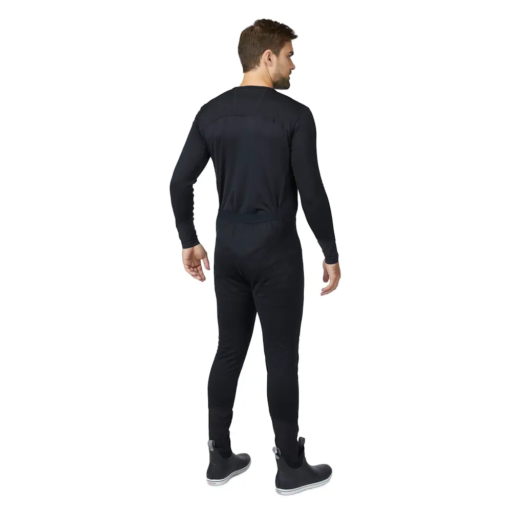 Back-side view of a man wearing Mustang Survival® Men’s Kazan Dry Suit Liner highlighting ergonomic seam placement and snug fit for optimal insulation.