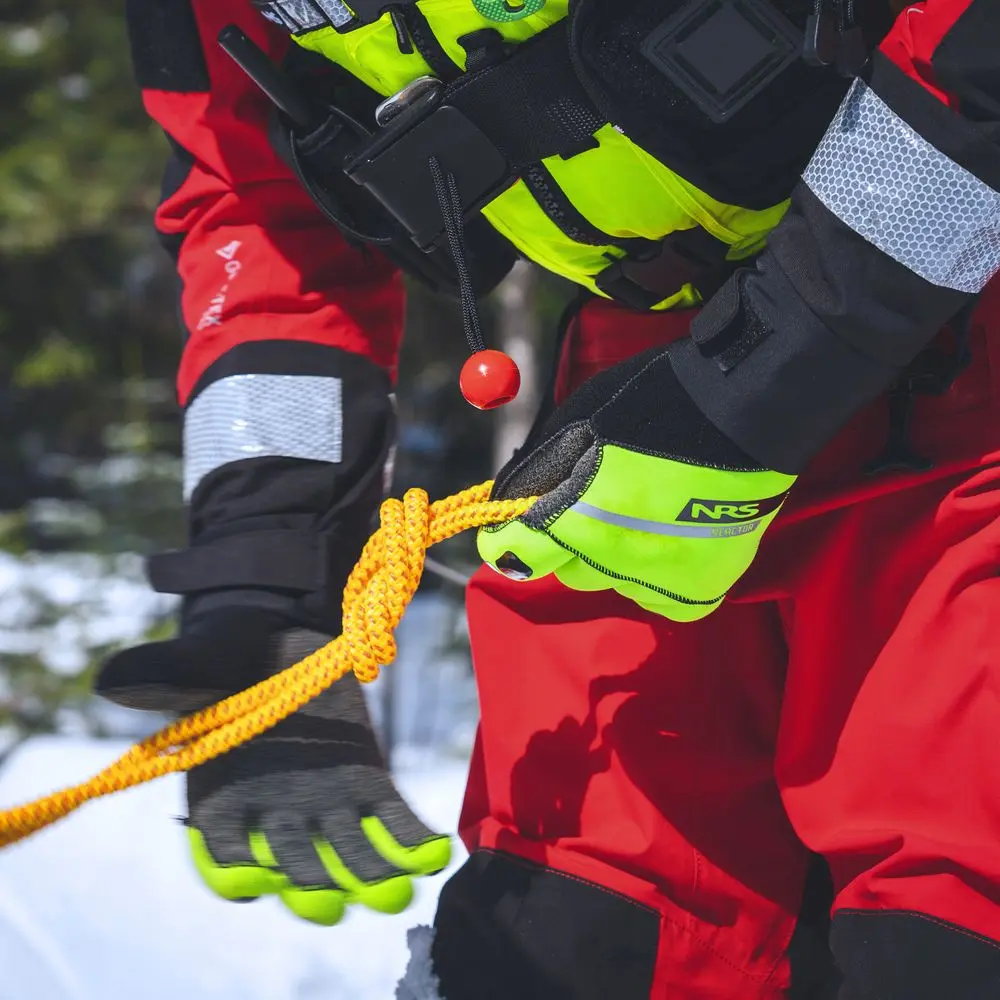 Close-up of a rescue worker wearing NRS Reactor Rescue Gloves, highlighting their durable design and secure grip for rescue operations.