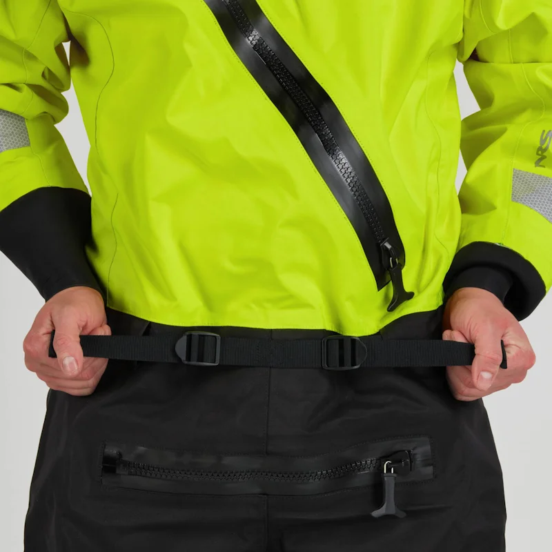 Closeup of a man wearing the NRS Ascent SAR Dry Suit in safety yellow, gripping the adjustable waist straps for a secure fit.