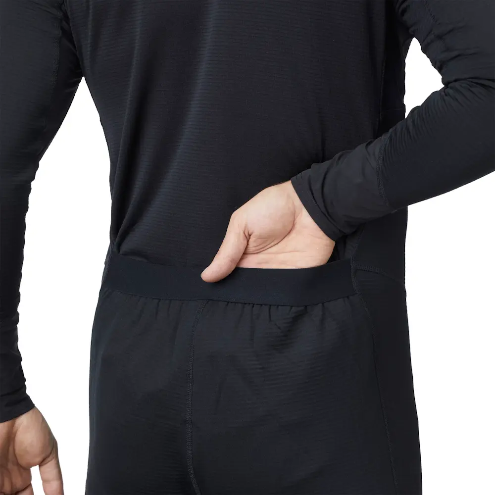 Closeup of back waist area on a man wearing Mustang Survival® Men’s Kazan Dry Suit Liner featuring flexible fabric and tailored seams for improved fit and movement.