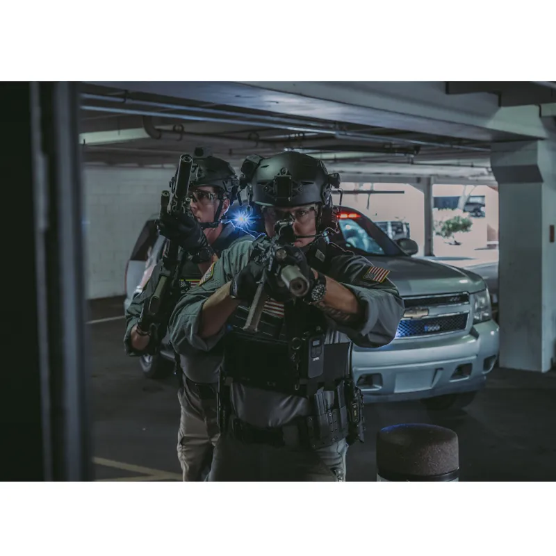 Two soldiers wearing the Team Wendy® EXFIL® Carbon Bump Helmet armed during an operation or training exercise, demonstrating real-world tactical use.