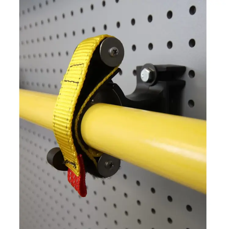 Close front right side view of Ziamatic™ SURE-GRIP 275 Tool/Equipment Mounts mounted and in use, securely gripping firefighting tools for reliable storage and rapid access during emergencies.