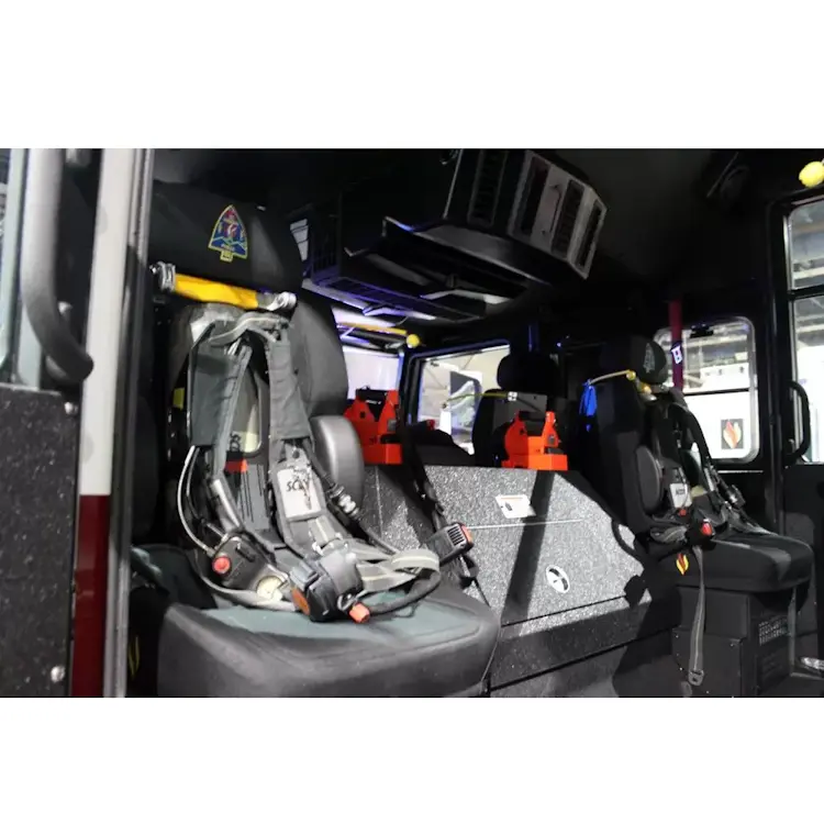 Two empty Ziamatic™ ROL-LOC Mechanical Brackets mounted on firetruck seats, ready to securely hold cylinders for fast access during emergencies.
