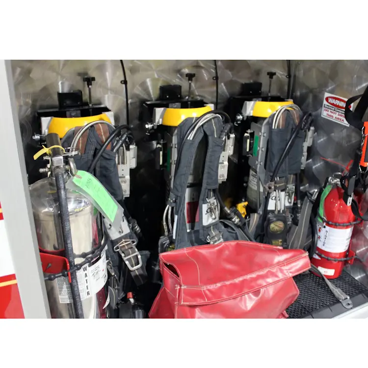 Three empty Ziamatic™ EZ-LOC Mechanical Brackets with Fixed Top Clamps mounted side by side, each equipped with shoulder carrying straps and ready to securely hold cylinders for emergency use.