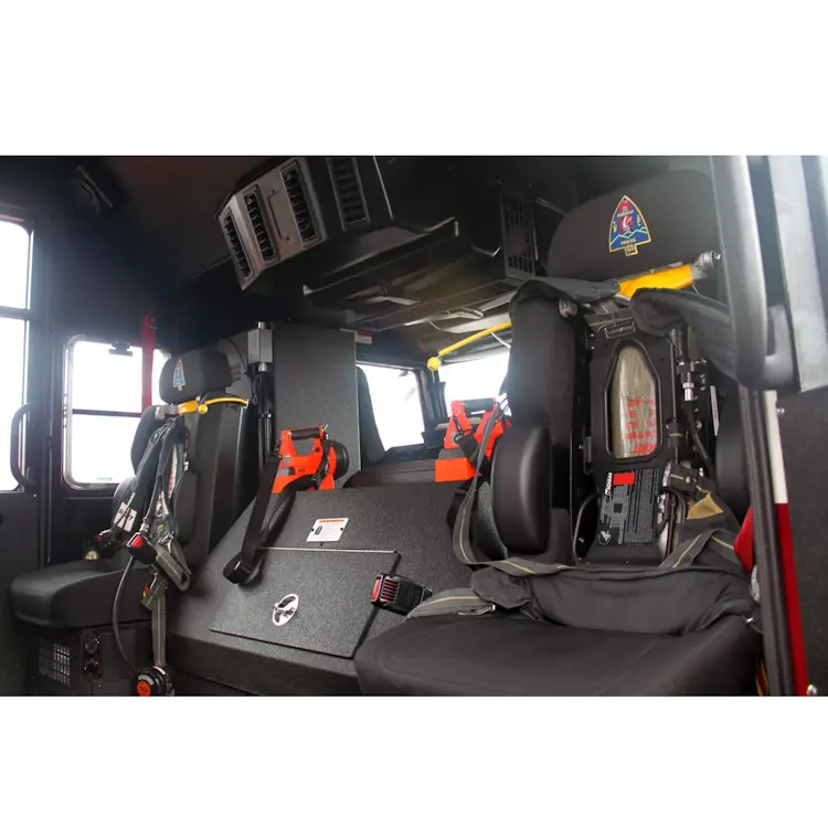 Two empty Ziamatic™ ROL-LOC Mechanical Brackets mounted on a firetruck seat, prepared to securely hold cylinders for rapid access during emergency response.