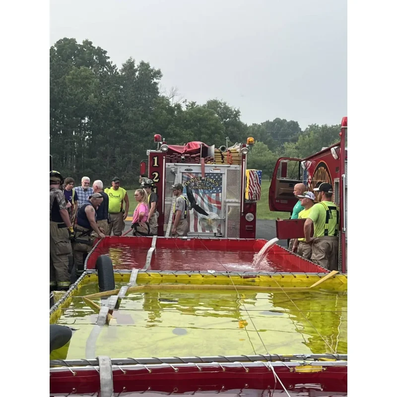 Multiple FOL-DA-TANK® Portable Folding Frame Tanks filled with water, arranged and ready for use in firefighting and emergency response operations.