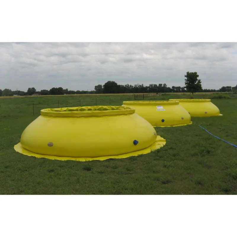 Three yellow Husky® self-supporting frameless portable water tanks with flared bases and side fittings set up in a grassy field.