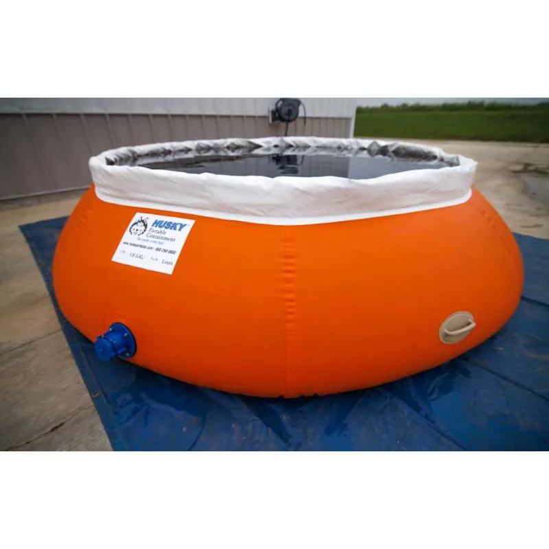 Orange Husky® self-supporting frameless portable water tank filled with water on a blue ground tarp, with a white upper collar and blue side outlet.