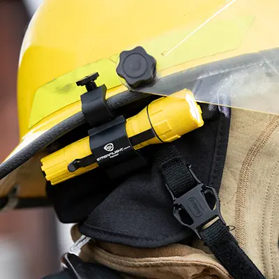 Streamlight® PolyTac® Flashlight attached to a helmet, providing hands-free, powerful illumination for tactical, industrial, and emergency response tasks.