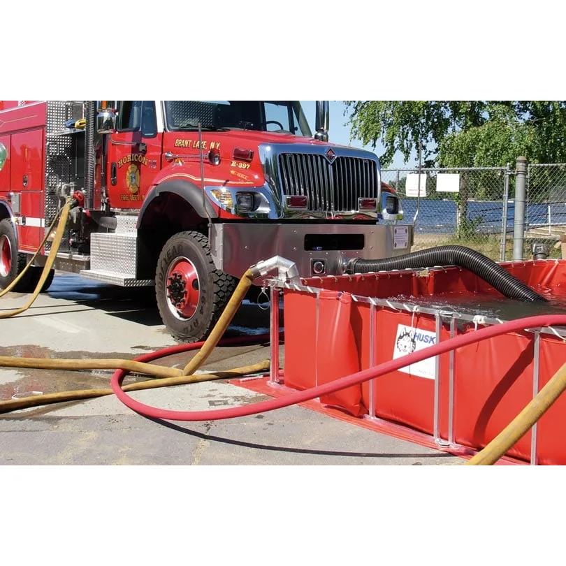 A Husky® Supply Line Bracket in use mounted on a water tank, securely holding a supply hose to ensure organized and efficient firefighting operations.