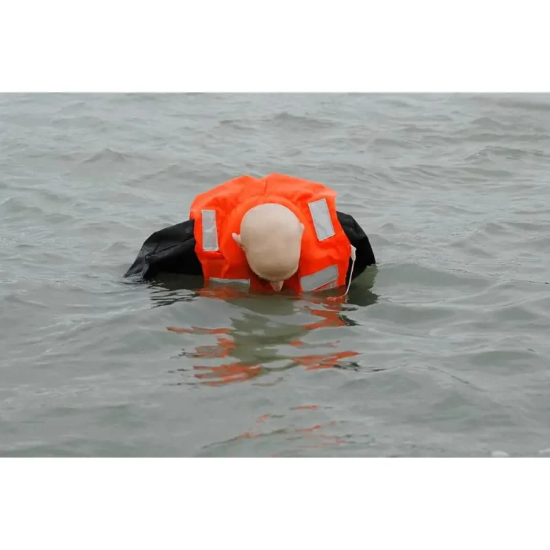 A Ruth Lee™ Advanced Water Rescue Manikin floating in the water wearing a life jacket, used for realistic water safety and rescue training exercises.