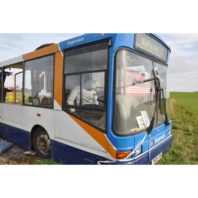 A Ruth Lee™ Multi Trauma Training Manikin with impalement injuries positioned inside the front section of a bus, staged for mass casualty and vehicle extrication training.