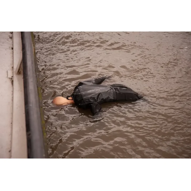 A Ruth Lee™ Advanced Water Rescue Manikin floating face-up on its back in the water, simulating an unconscious casualty for rescue training.