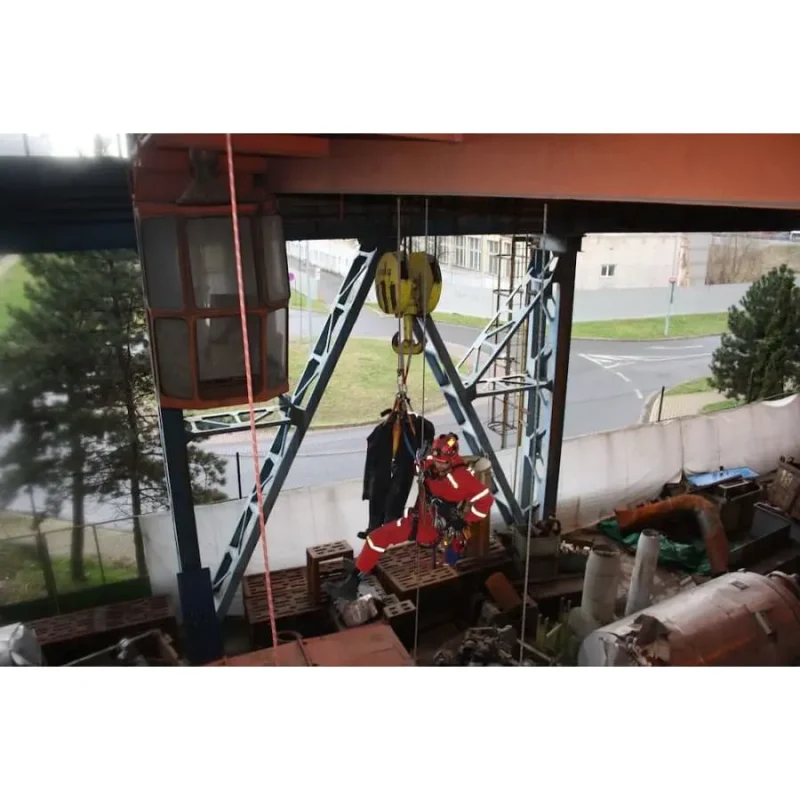 Ruth Lee™ Working at Height Training Manikin being hoisted in an indoor industrial area, highlighting controlled high-angle rescue training with proper rigging and team coordination.