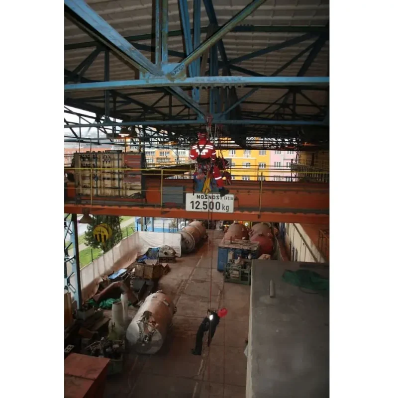 Ruth Lee™ Working at Height Training Manikin hoisted in an indoor industrial setting, showcasing precise rigging and safe lifting techniques during high-angle rescue training exercises.