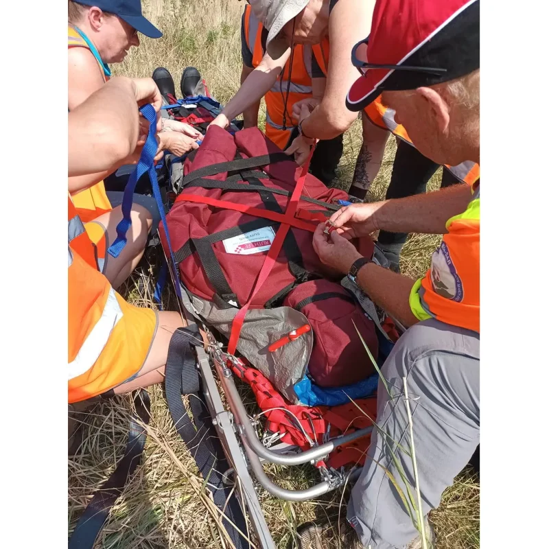 A Ruth Lee™ Duty Plus Manikin secured and transported on a stretcher by rescue personnel during a simulated emergency evacuation training exercise.