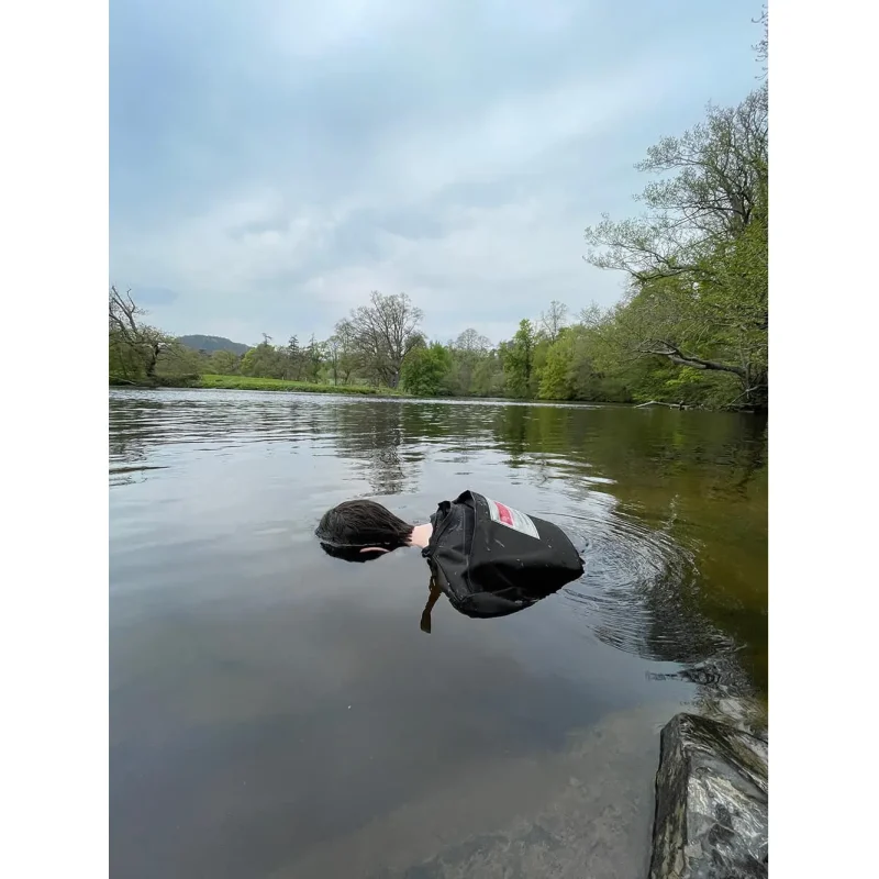 A Ruth Lee™ Advanced Water Rescue Toddler manikin floating on its back in a body of water, simulating a child casualty for aquatic rescue training.