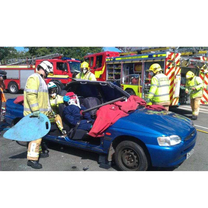 A Ruth Lee™ Multi Trauma Training Manikin with realistic impalement injuries seated in the front passenger seat of a car, staged for vehicle extrication and trauma response training.