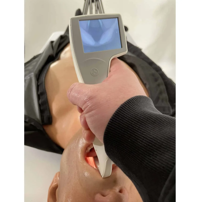 A Ruth Lee™ Advanced Water Rescue Manikin undergoing a medical examination with a device used to inspect the mouth and airway during rescue training.