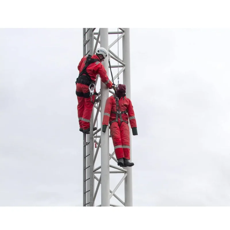 Ruth Lee™ Working at Height Training Manikin positioned high on a tower being rescued by a team, demonstrating advanced rope rescue techniques and safety procedures in elevated environments.