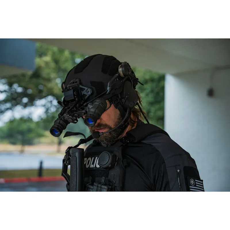 Side-angle view of a tactical operator wearing a Team Wendy® helmet with mounted night vision goggles, communication headset, and law enforcement gear during low-light operations.